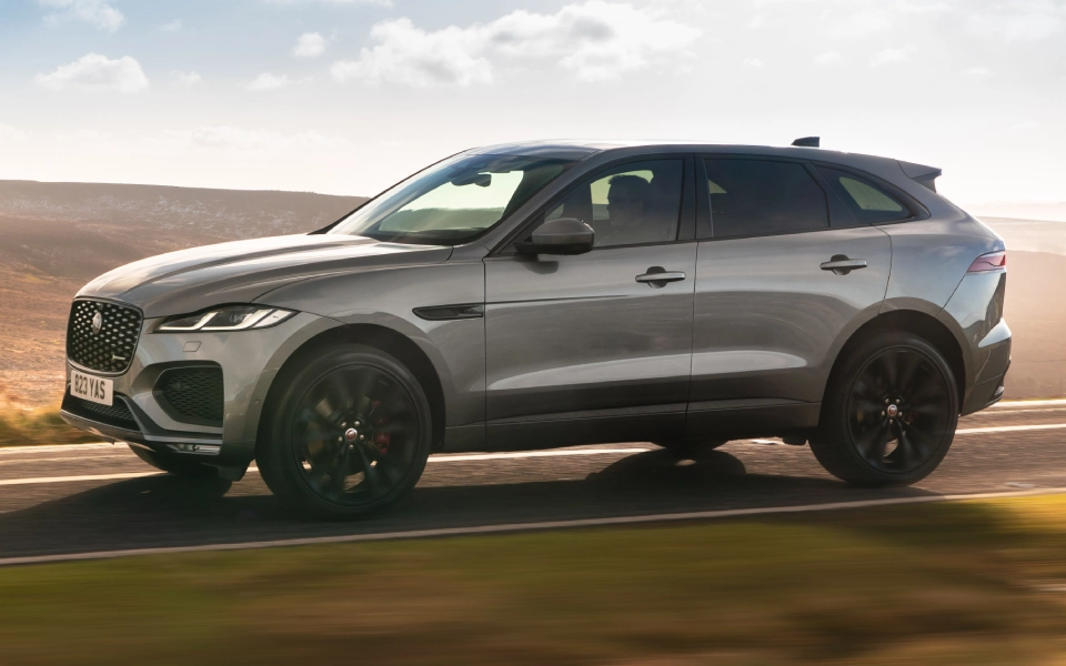 A silver Jaguar model F-Pace on the road