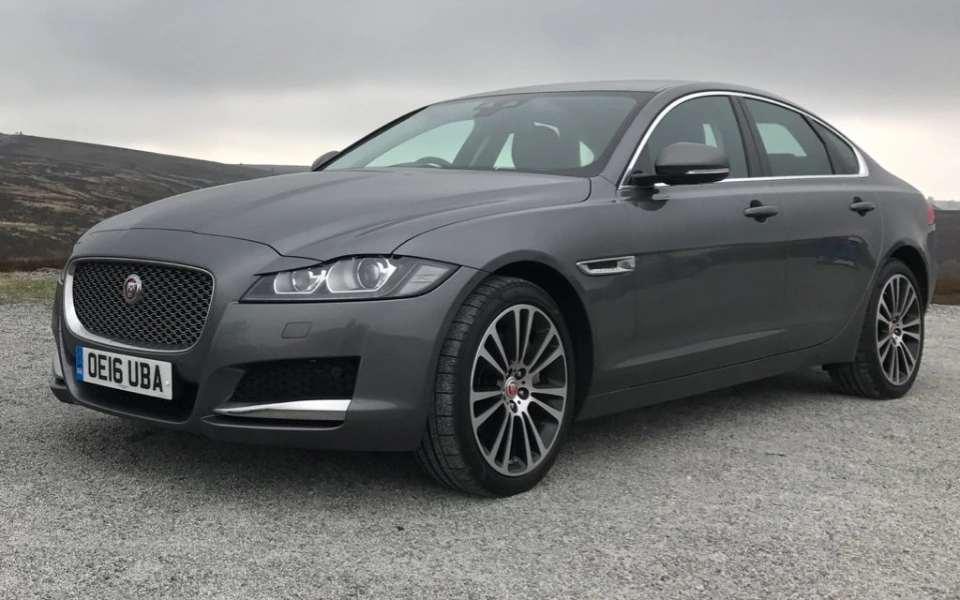 A Jaguar XF on the road with Jaguar insurance to keep you safe